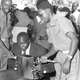 Idi Amin playing an accordion on Buvuma Island in October 1971.